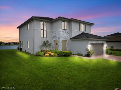 View of front facade featuring a garage and a yard | Image 2