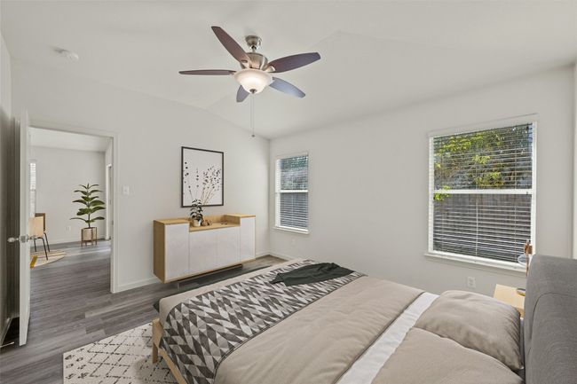 Bedroom with ceiling fan, baseboards, lofted ceiling, and wood finished floors | Image 18