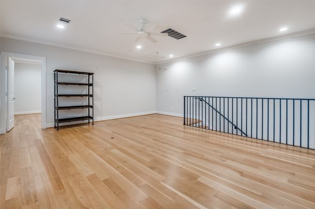 Empty room with visible vents, light wood-style flooring, ornamental molding, and a ceiling fan | Image 23