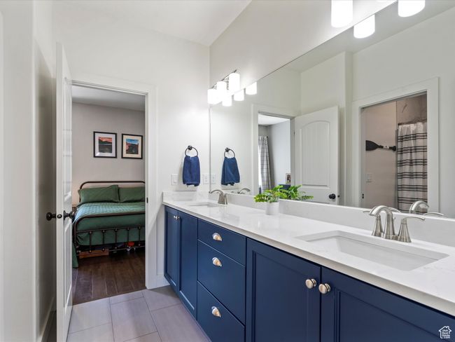 Bathroom with tile patterned floors and double vanity | Image 38
