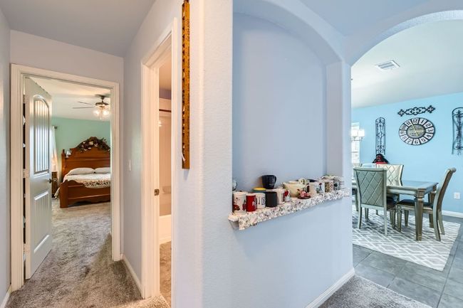 Hall featuring baseboards, visible vents, and arched walkways | Image 21