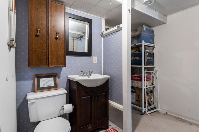 You'll also find a convenient ¾ bathroom and a laundry area equipped with a utility sink and ample storage. | Image 10