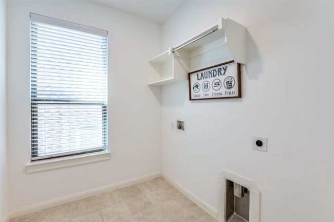 Spacious laundry room featuring washer and electric dryer hookups, a dedicated laundry area, and elegant baseboards, offering both functionality and convenience. | Image 30