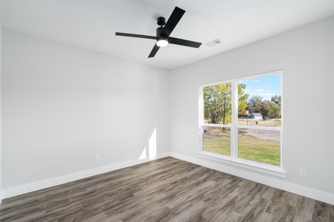 Unfurnished room with ceiling fan and dark hardwood / wood-style flooring | Image 7