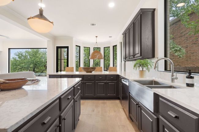 Abundant cabinetry lines the walls, ensuring plenty of storage for kitchen essentials, while keeping the space clean and clutter-free. | Image 11