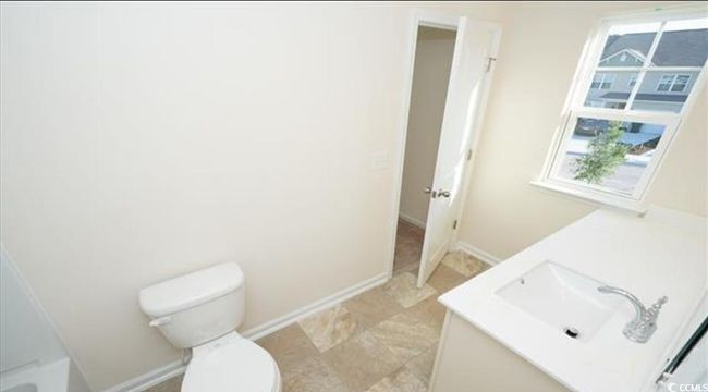 Bathroom featuring baseboards, toilet, and vanity | Image 16