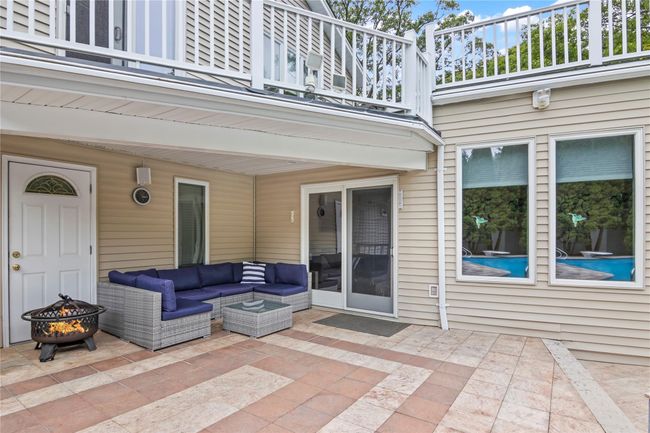 View of patio featuring a balcony and an outdoor living space with a fire pit | Image 33