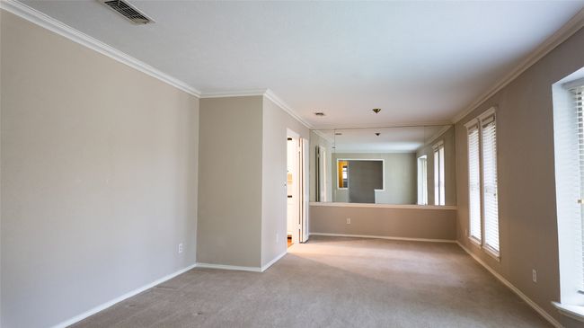 Carpeted empty room with crown molding, baseboards, and visible vents | Image 14