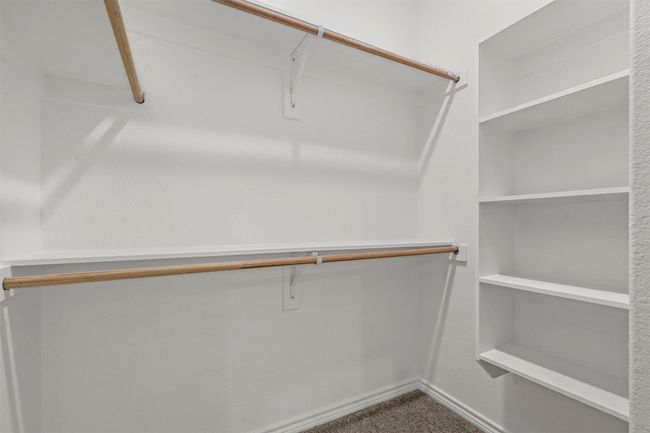 Walk in closet featuring carpet flooring | Image 34