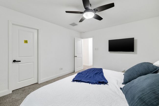 Carpeted bedroom with ceiling fan | Image 18