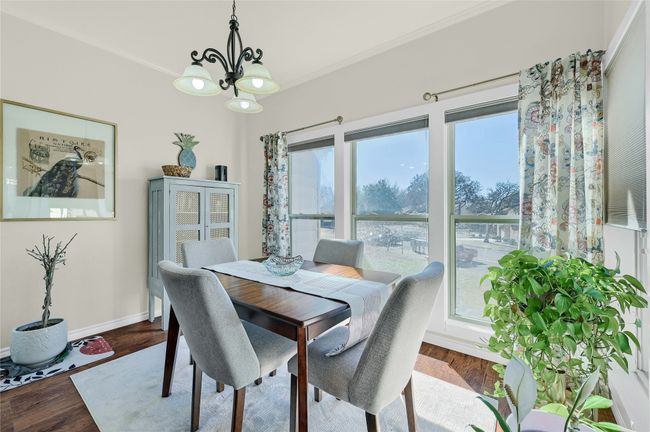 Dining room featuring a chandelier, dark wood-style flooring, baseboards, and ornamental molding | Image 16