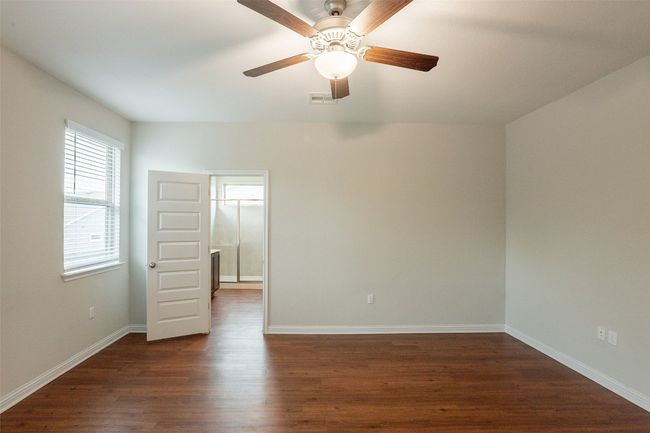 Spare room featuring ceiling fan, dark wood finished floors, baseboards, and visible vents | Image 21