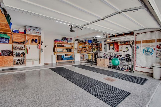 A garage for the neighbors to envy! A true 3-car with epoxy flooring and lots of built-in shelves for extra storage | Image 34