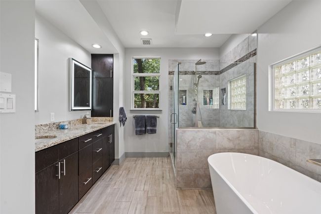 Bathroom with a soaking tub, double vanity, a stall shower, and recessed lighting | Image 4
