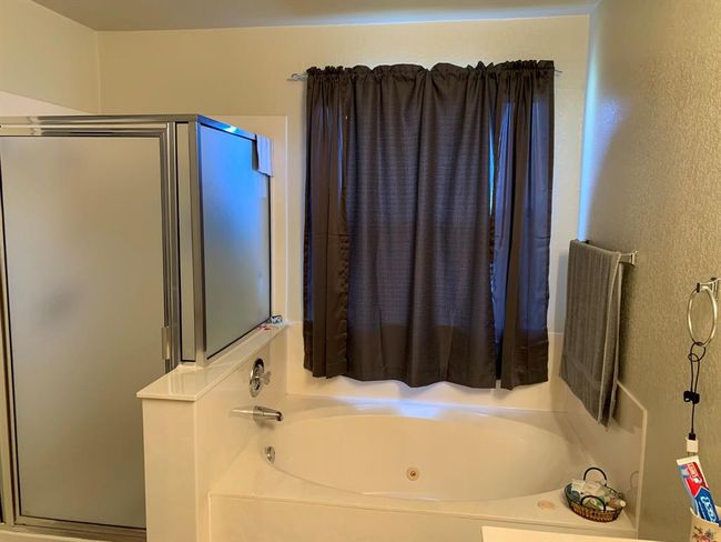Relax in a jet tub for a bath or jump into a walk in shower. Toilet has it's own room for privacy. | Image 18