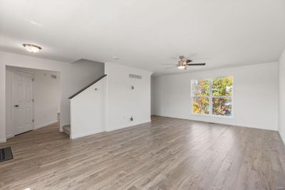 Unfurnished living room featuring light hardwood / wood-style floors and ceiling fan | Image 3