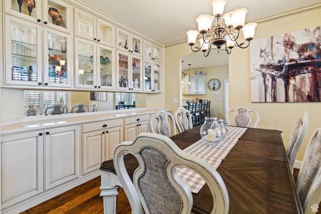 Dining room with dark hardwood / wood-style floors and a notable chandelier | Image 25