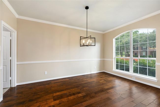 A large window fills the formal dining area with natural light, creating an open and inviting atmosphere. | Image 8