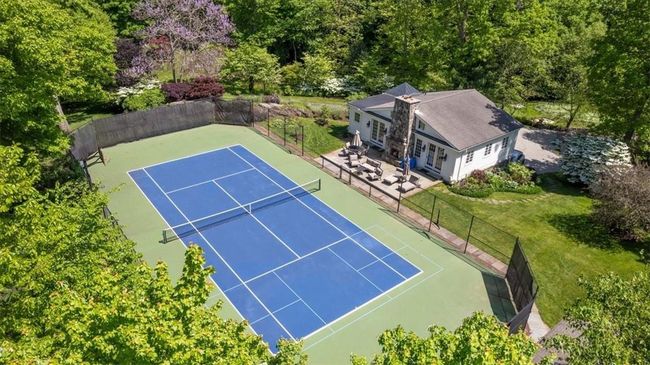 View of sport court with a patio area and a yard | Image 29