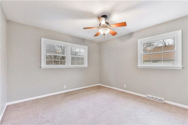 Unfurnished room with ceiling fan and carpet | Image 14