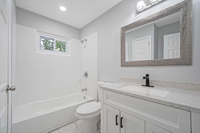 Bathroom featuring toilet, vanity, shower / bathing tub combination, and recessed lighting | Image 9