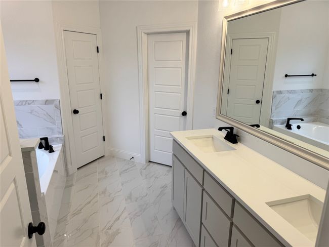 Bathroom featuring vanity and a tub | Image 8