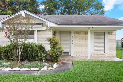 Cute front porch waiting for a swing or bench for some afternoon sweet tea | Image 2