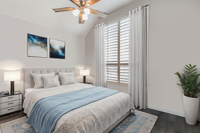 Bedroom featuring lofted ceiling, dark wood-type flooring, multiple windows, and ceiling fan | Image 21