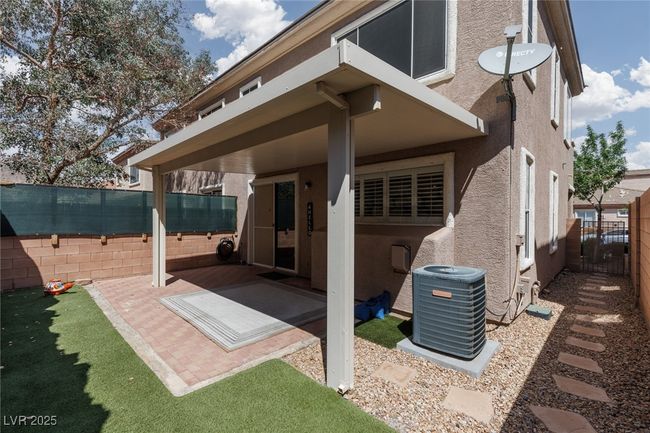 Rear view of property with a patio area, central AC, a fenced backyard, and stucco siding | Image 27
