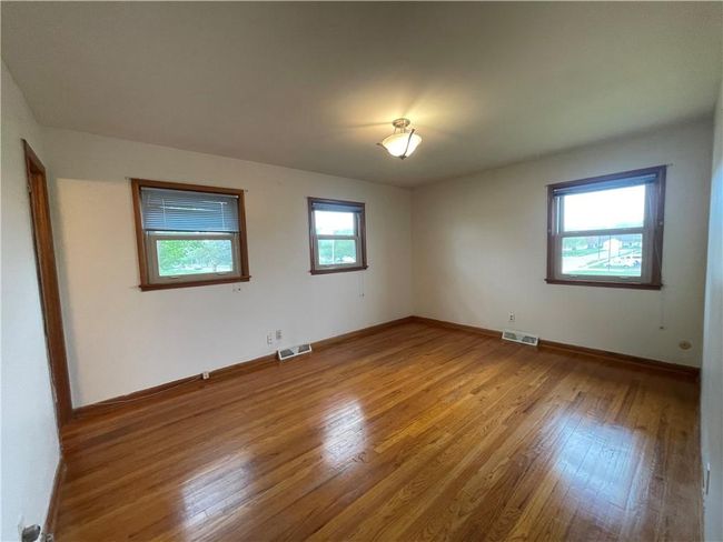 Spare room featuring visible vents, wood finished floors, and baseboards | Image 15