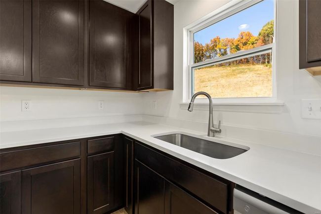 Kitchen with dishwasher, sink, and dark brown cabinets | Image 12