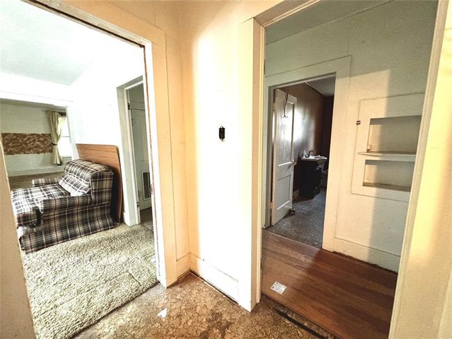 View from the kitchen into the dining room and hallway to bedrooms. Soft spots in flooring throughout. Be CAREFUL where you step. | Image 33