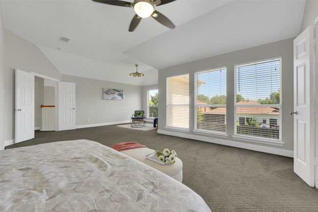 Bedroom with carpet flooring, lofted ceiling, and ceiling fan | Image 25