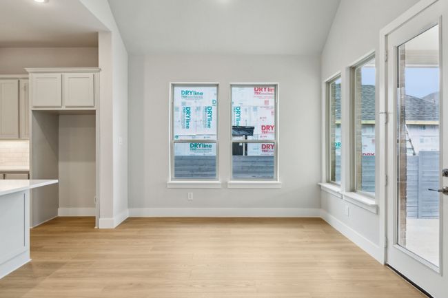 Unfurnished dining area with light wood-style flooring and baseboards | Image 34