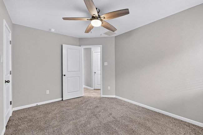 Unfurnished bedroom featuring carpet flooring and ceiling fan | Image 26