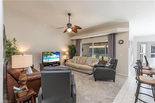 Living room featuring light tile patterned flooring, ceiling fan, and baseboards | Image 11