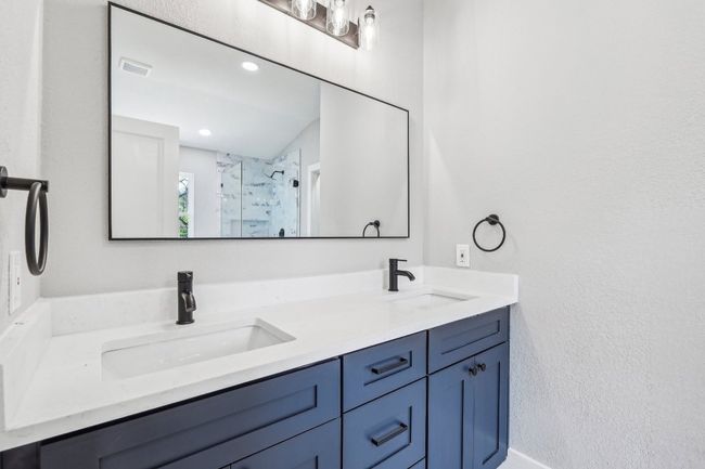 Bathroom with double vanity and a stall shower | Image 22