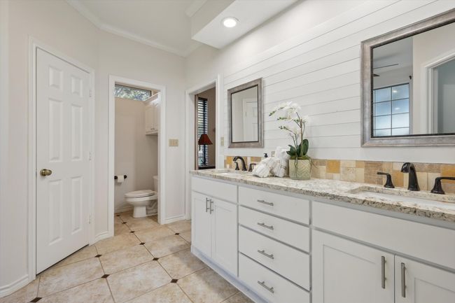 Primary Bathroom featuring double vanity, tile patterned flooring, and ornamental molding | Image 22