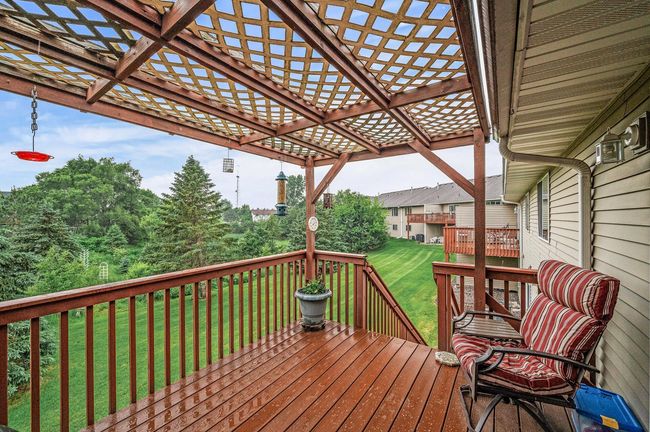 The deck with pergola backs up to a serene pond, offering both privacy and relaxation. | Image 13