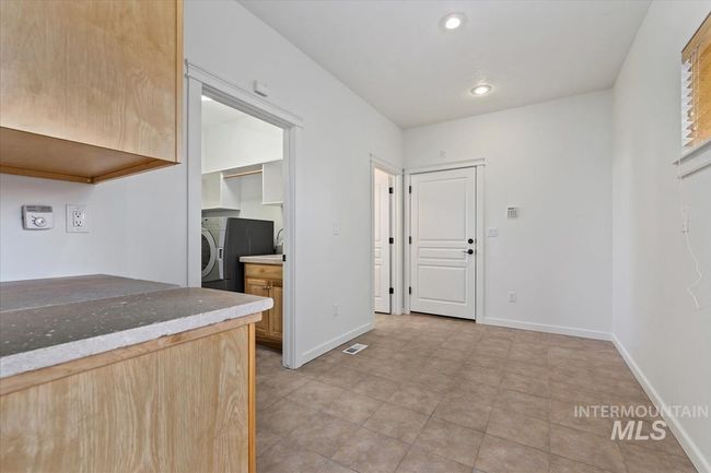 Kitchen featuring washer / clothes dryer, recessed lighting, and light tile patterned floors | Image 47