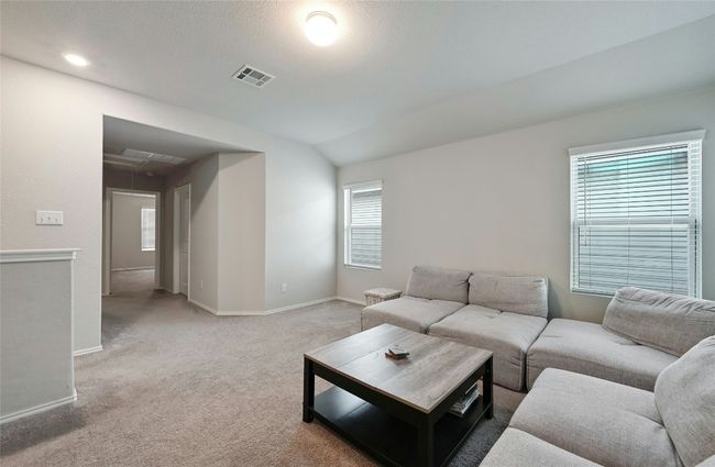 Living area with attic access, carpet, and vaulted ceiling | Image 13