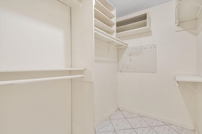 Walk in closet featuring marble finish floor | Image 23