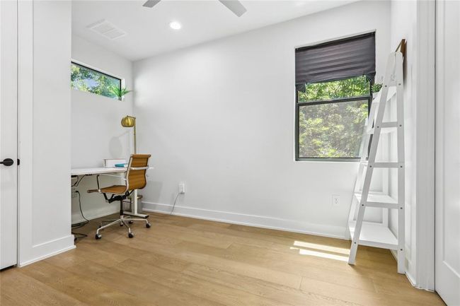 Office area featuring light wood-type flooring, ceiling fan, and recessed lighting | Image 23
