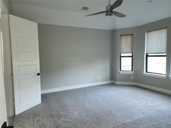 Discover the master bedroom with a beautiful master bath on the first floor. | Image 13