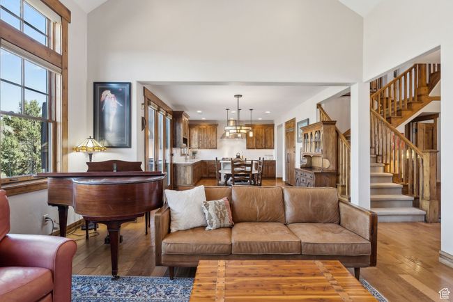 Living area featuring stairs, recessed lighting, a towering ceiling, and hardwood / wood-style floors | Image 4