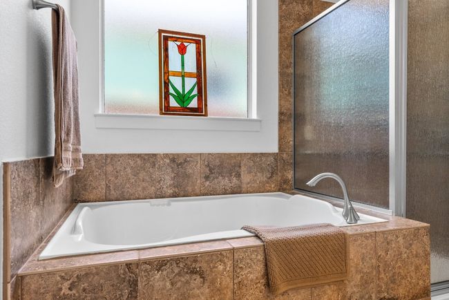 Bathroom featuring a bath and a healthy amount of sunlight | Image 19