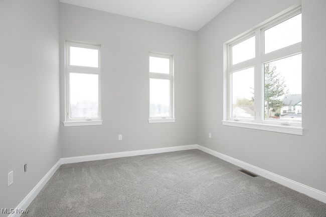 Carpeted empty room with a wealth of natural light | Image 20