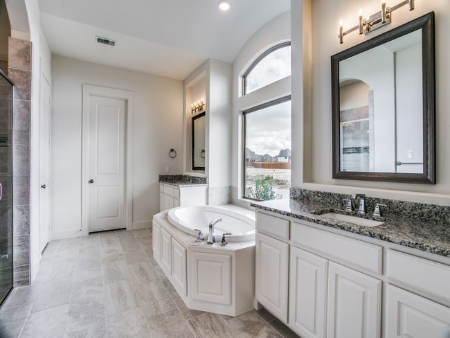 Bathroom with a stall shower, two vanities, a bath, and recessed lighting | Image 15