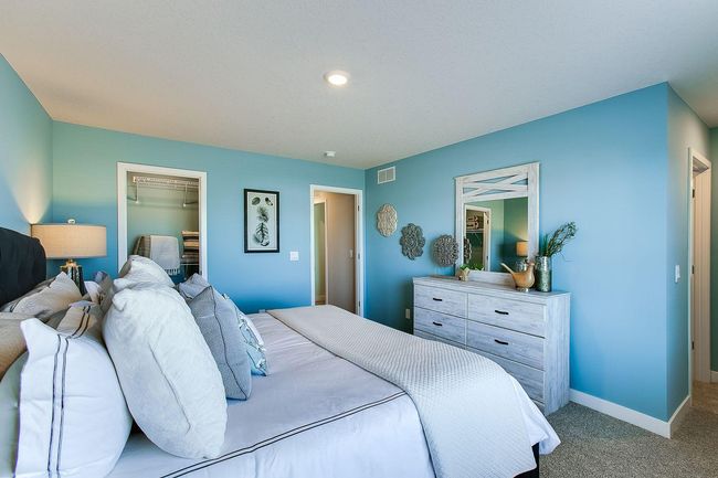 Another view of the primary bedroom in the Finnegan model with bathroom en-suite. Photos of model home. Colors and options may vary. Ask Sales Agent for details. | Image 22