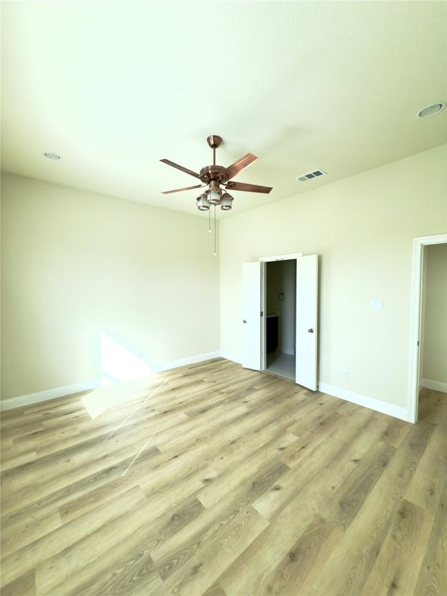 Unfurnished bedroom with light wood finished floors, baseboards, and ceiling fan | Image 8